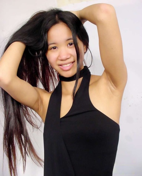 Young Chinese girl with tiny tits shows her shiny ass and naked pussy at once