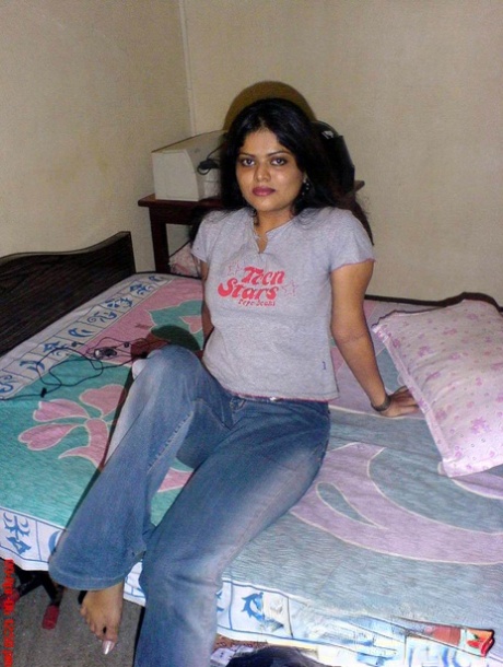 Petite Indian girl uncups big naturals after removing blue jeans