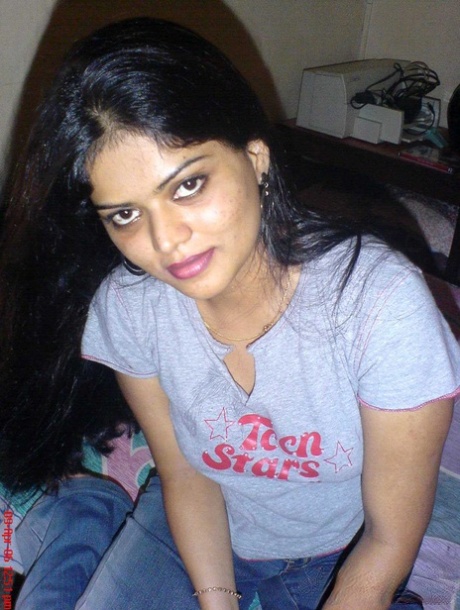 Petite Indian girl uncups big naturals after removing blue jeans
