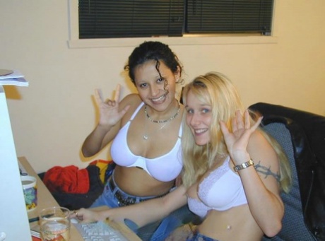 Lesbian girls 69 on a bed while prepping for a strapon cock