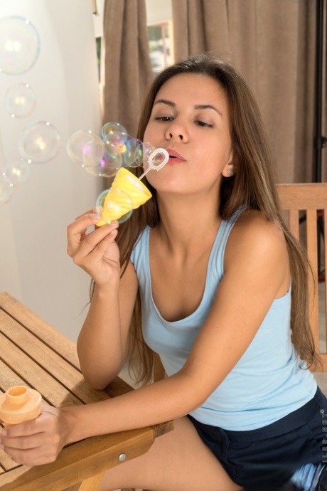 Young looking girl Baby Shine fingers her bald twat after blowing soap bubbles