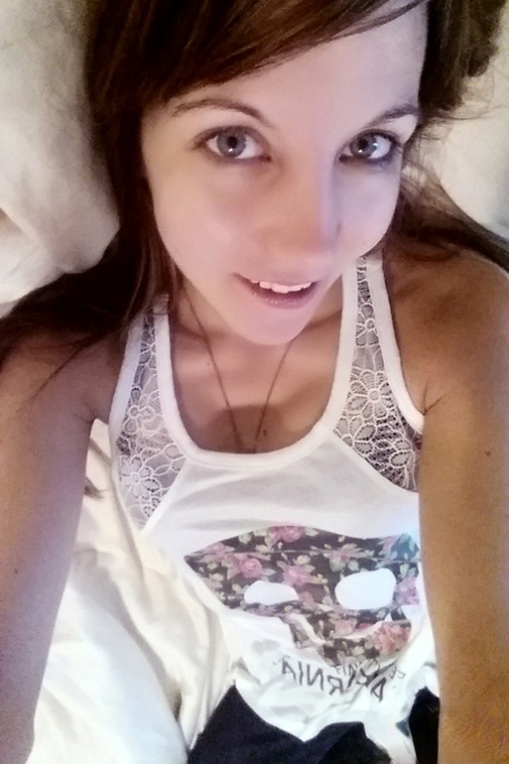 Young brunette Andi Land is captured in clothed and nude candid acts