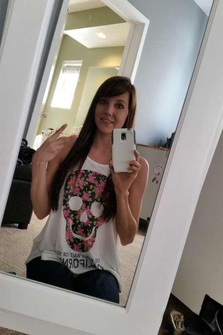 Young brunette Andi Land is captured in clothed and nude candid acts