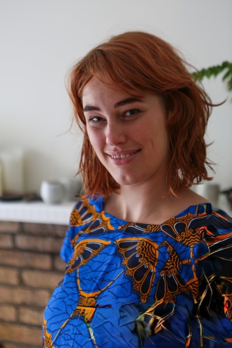 Natural redhead Molly Broad pets her pussy after getting naked