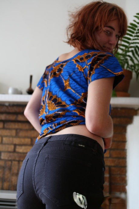 Natural redhead Molly Broad pets her pussy after getting naked
