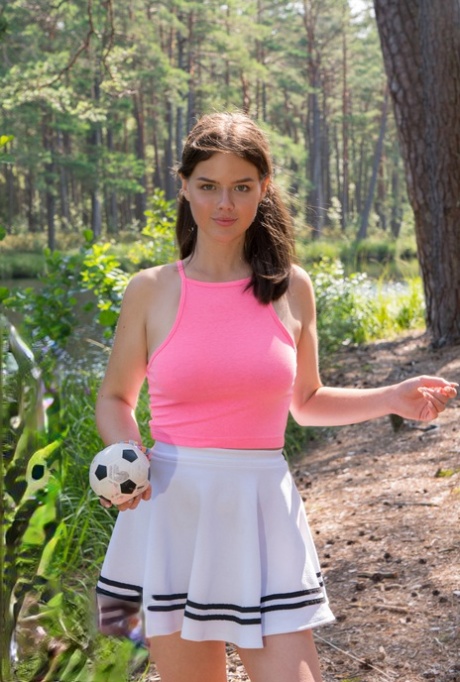 Busty girl Di removes her short skirt to get totally naked in the woods