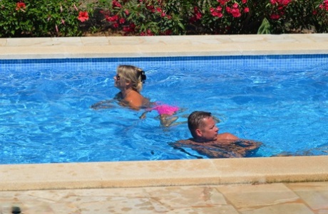 Mature amateur Sweet Susi has her cunt pleasured by a gf on the side of a pool