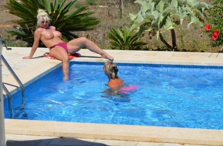 Mature amateur Sweet Susi has her cunt pleasured by a gf on the side of a pool