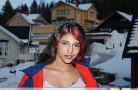 Sexy Indian teen poses on snow-covered ground before going nude on a bed