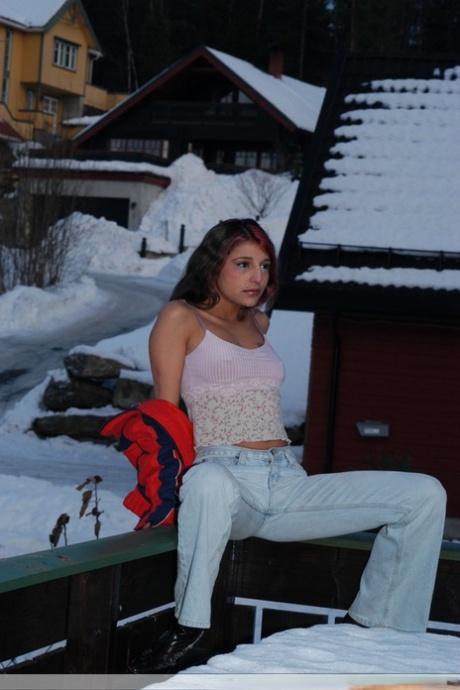 Sexy Indian teen poses on snow-covered ground before going nude on a bed