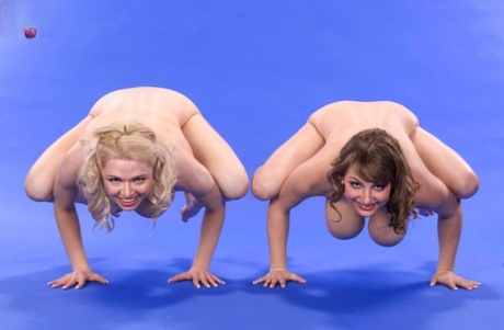 Busty females show off their hooters and flexibility in the nude together