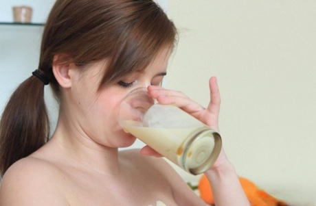 Pregnant girl spills milk over her swollen breasts and huge belly
