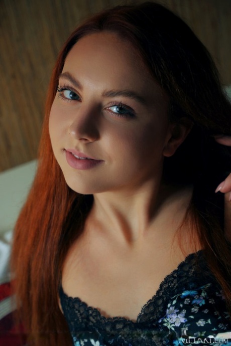 Young redhead Valery Leche shows her meaty labia lips and tiny tits on her bed
