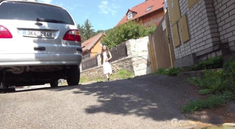Lara Fox takes an urgent piss outside of a building during the day