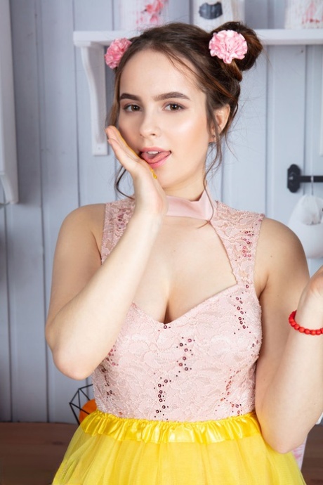 Cute teen Wendy exposes her full breasts and tight pink pussy in puffballs