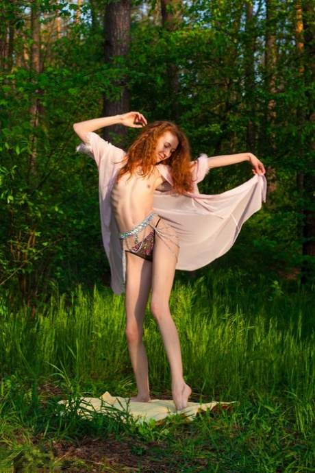 Skinny redhead Veronika makes her nude debut on a blanket near the woods
