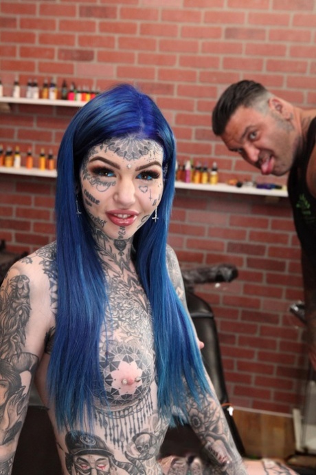 Heavily tattooed girl Amber Luke poses naked in a tattoo shop