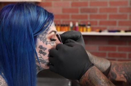 Heavily tattooed girl Amber Luke poses naked in a tattoo shop