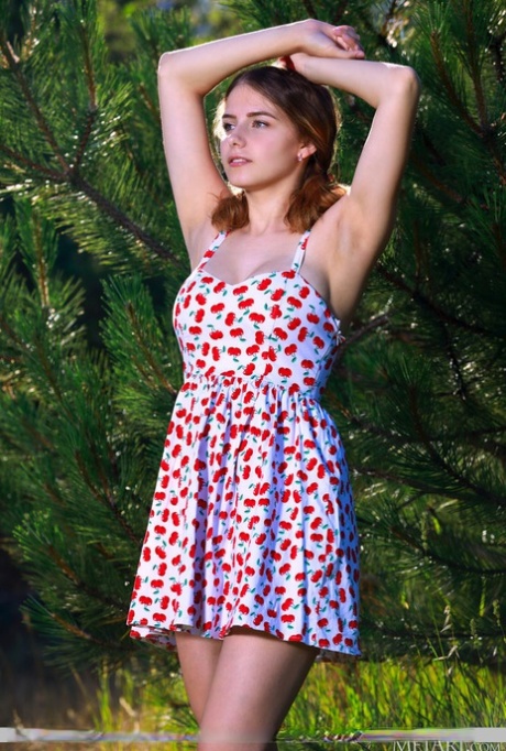 Young redhead Dakota Pink sports full breasts while showing her bald twat
