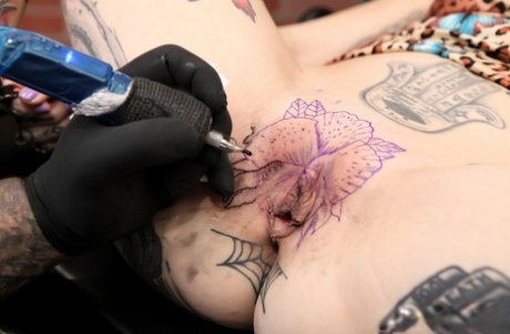 Inked girl River Dawn gets a pussy tattoo before sucking the cum from a cock