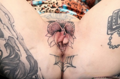Inked girl River Dawn gets a pussy tattoo before sucking the cum from a cock