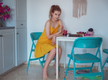 Natural redhead Sienna highlights her tight pink pussy after undressing