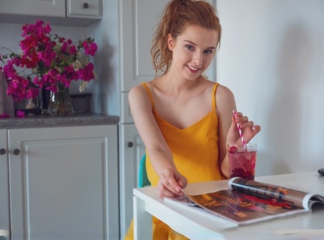 Natural redhead Sienna highlights her tight pink pussy after undressing