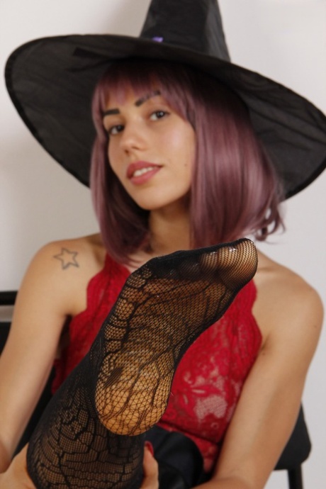 Pretty witch Petra takes off her high heels while wearing sexy hosiery