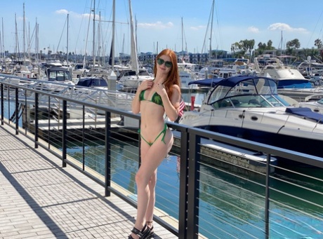 Natural redhead Jane Rogers doffs a bikini before an ass licking blowjob