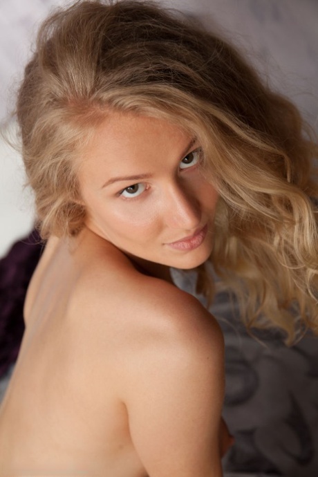 Young blonde Naomi Kiss casts alluring looks while modelling in the nude