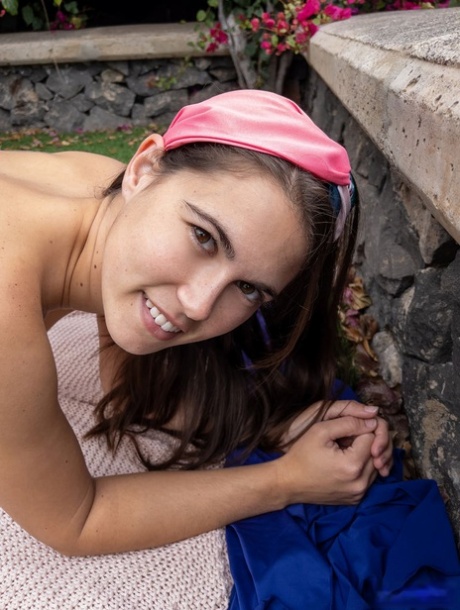 Girl next door type with big boobs Nina Sphinx gets naked in a backyard