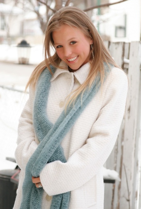 Pretty blonde Dawson Miller flashes her great body on snow-covered ground