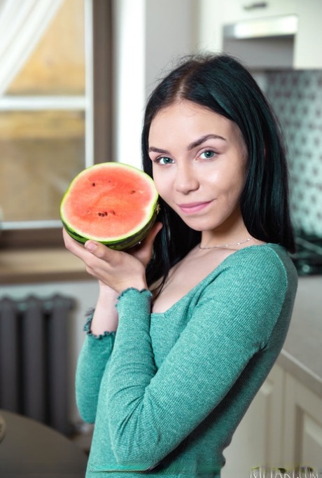 Dark haired teen Diamond gets totally naked while consuming a watermelon