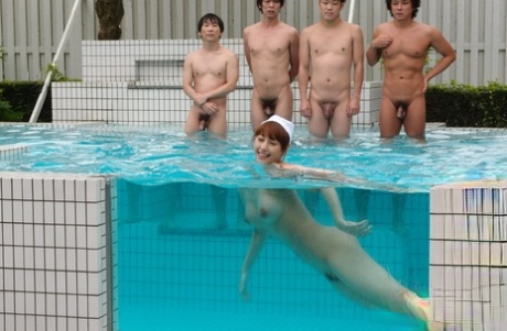 Redheaded Japanese girl Seshiru Kurosaki skinny dips before a gangbang