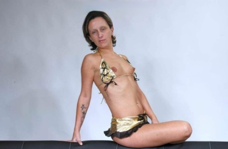 First timer Ela Engel frees her tiny tits from a bikini on a sofa