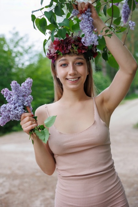 Nice teen Arete releases her great body from a dress during solo action