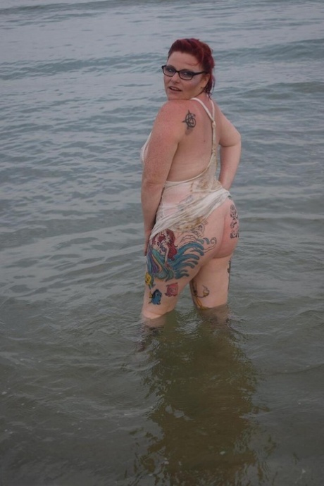 Mature UK redhead Mollie Foxxx exposes her tits and pussy while in the ocean