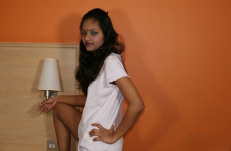 Indian female Divya lifts up a white dress to expose her vagina