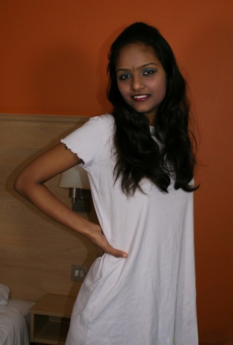 Indian female Divya lifts up a white dress to expose her vagina