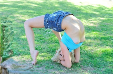 Flexible slut in short dress stretches long legs outdoors & dildos her cunt