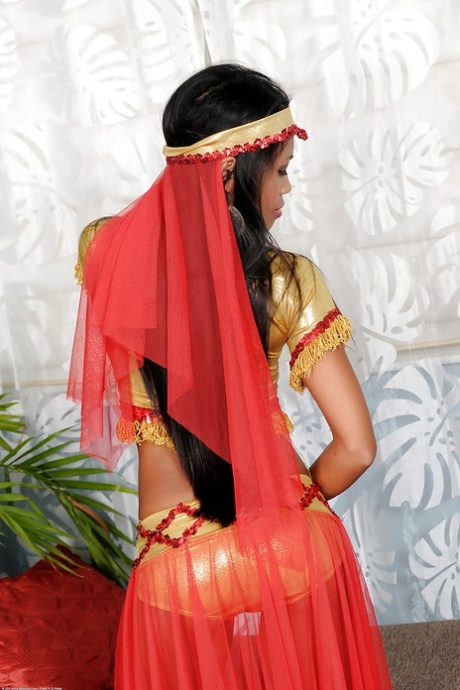 Naughty latina in exotic outfit undressing and spreading her slit