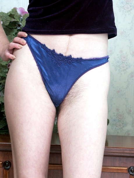 Delightful babe Tasja stripping in blue panties and showing hairy snatch