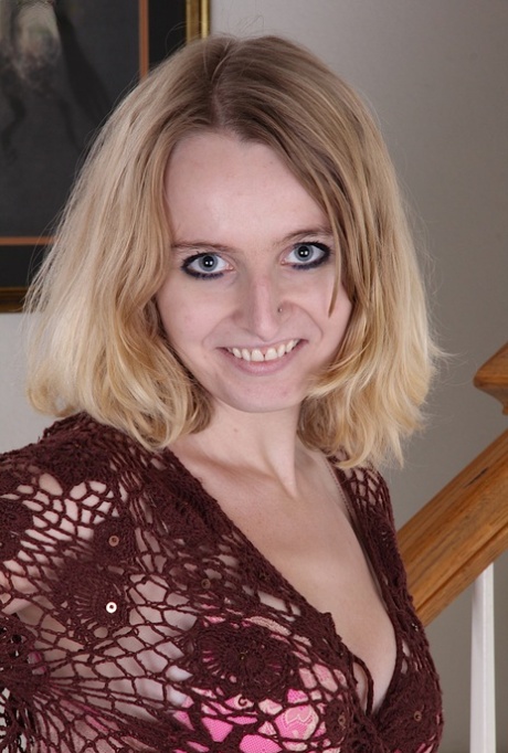 Aged blonde woman Annabelle pulling down jeans to expose pink cunt