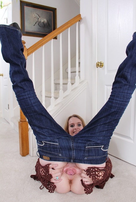 Aged blonde woman Annabelle pulling down jeans to expose pink cunt