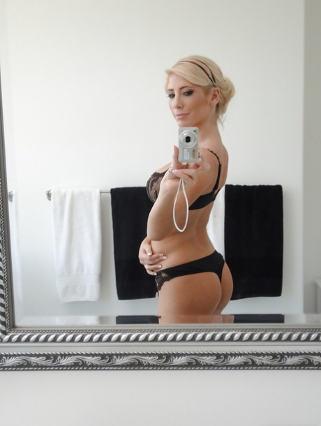 Beautiful blonde Tasha Reign taking selfies in mirror while removing pretties