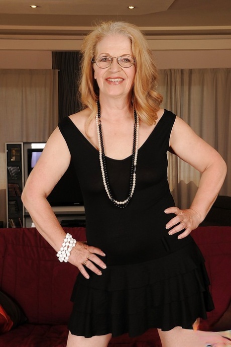 Naughty granny in glasses revealing her big flabby jugs and shaved cunt
