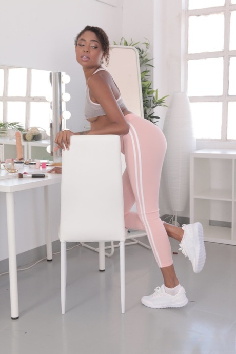 Ebony with a lovely bosom Luna Corazon reveals her long legs and sweet muff