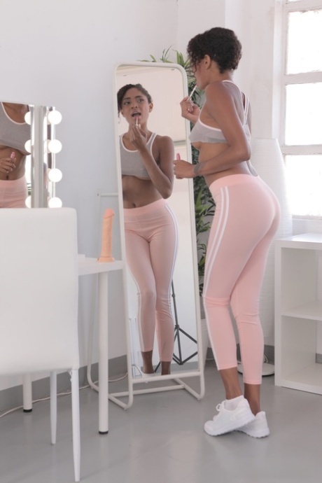 Ebony with a lovely bosom Luna Corazon reveals her long legs and sweet muff