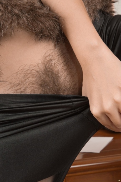Amateur slut Melody shows her inviting hairy pussy in a home striptease