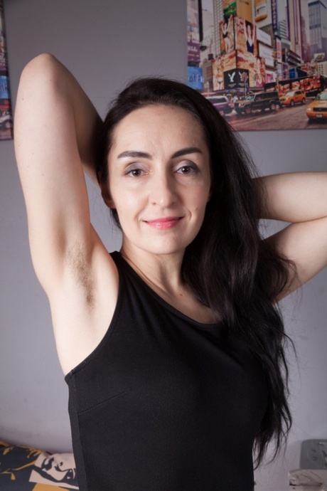 Brunette MILF Di Devi strips to flaunt hairy armpits & hairy pussy in her room